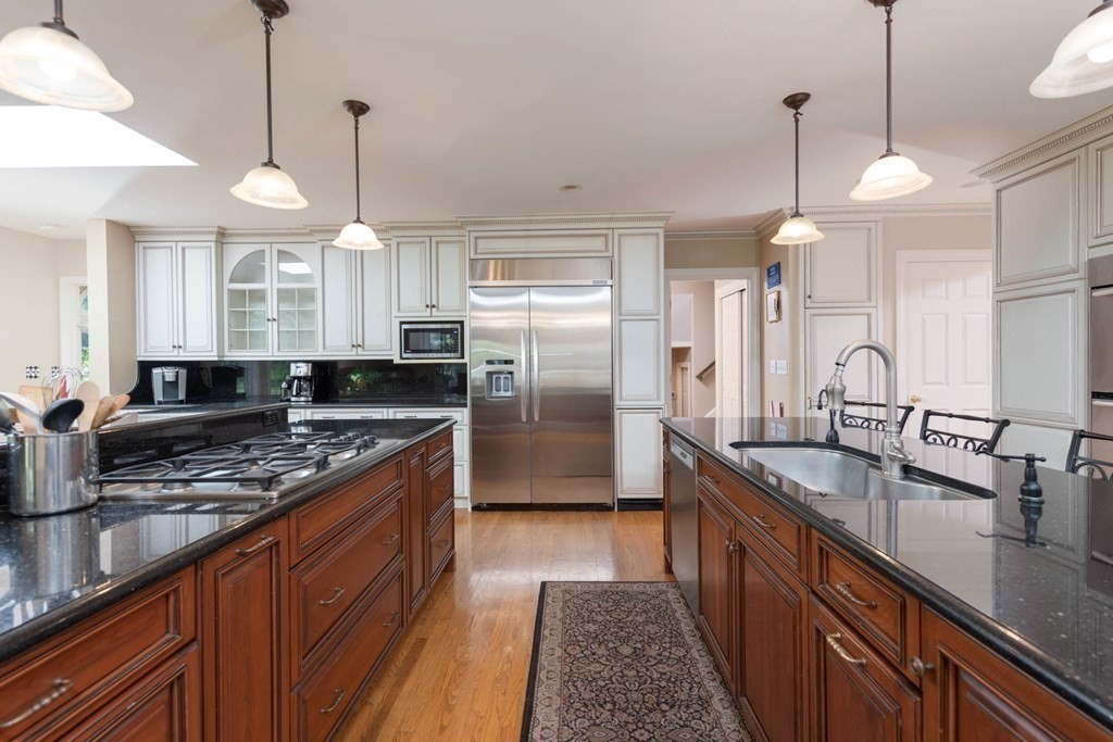 4 Elliston Road Weston, MA 02493 - Photo 10 of 36 a kitchen with stainless steel appliances granite countertop a sink a stove and a wooden floors