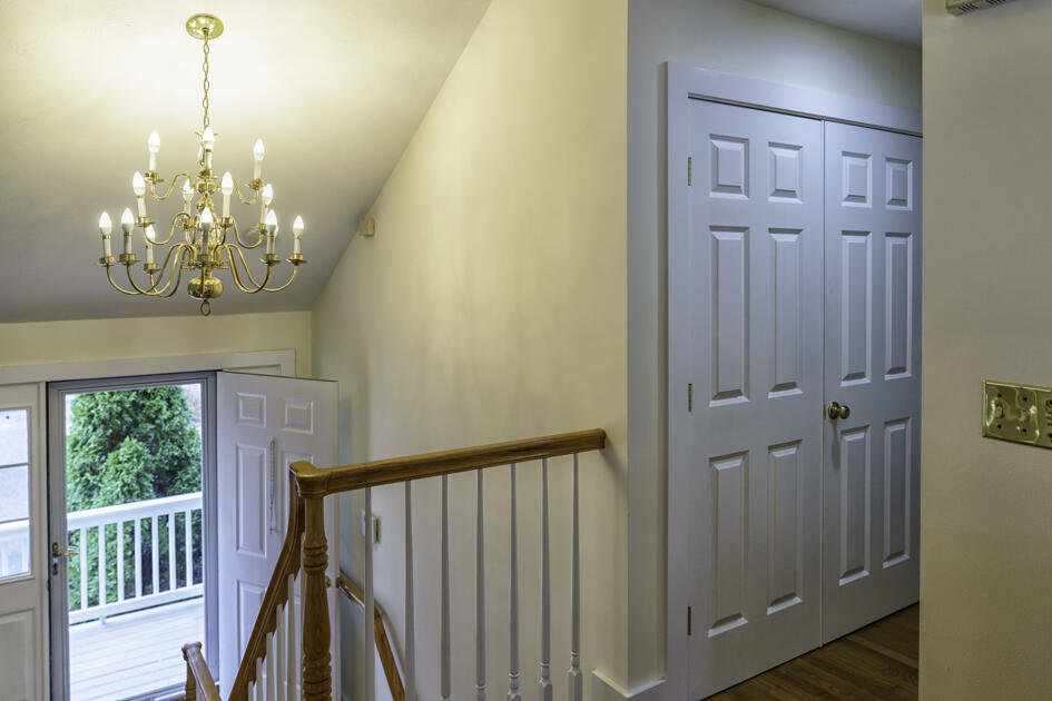 488 Upper County Road Dennis Port, MA 02639 - Photo 11 of 35 a view of a chandelier in big room with wooden floor