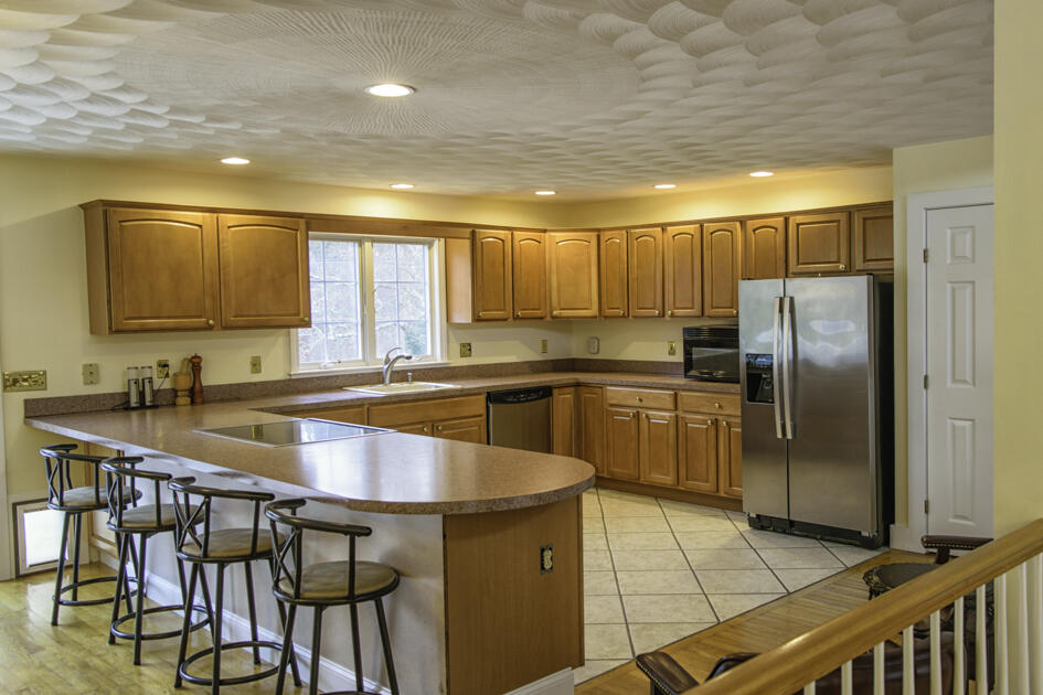 488 Upper County Road Dennis Port, MA 02639 - Photo 14 of 35 a kitchen with granite countertop a sink appliances cabinets and a counter top space