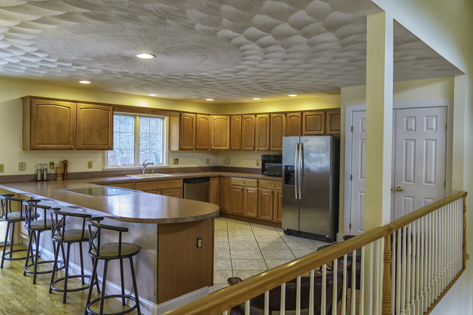488 Upper County Road Dennis Port, MA 02639 - Photo 16 of 35 a kitchen with stainless steel appliances granite countertop a refrigerator a sink and a stove