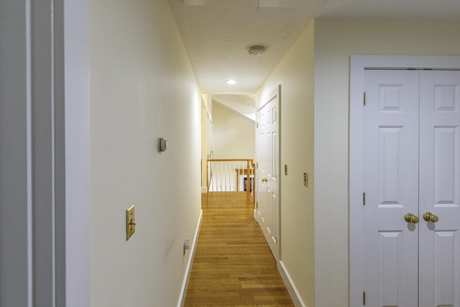 488 Upper County Road Dennis Port, MA 02639 - Photo 17 of 35 a view of a hallway with wooden floor and a glass door