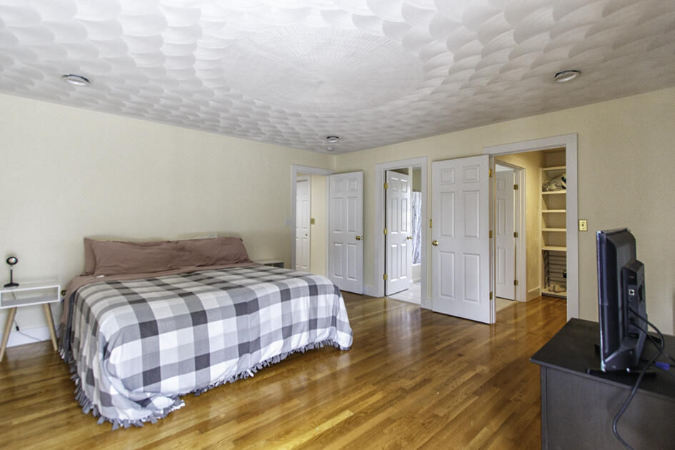 488 Upper County Road Dennis Port, MA 02639 - Photo 20 of 35 a bedroom with a bed and a flat screen tv