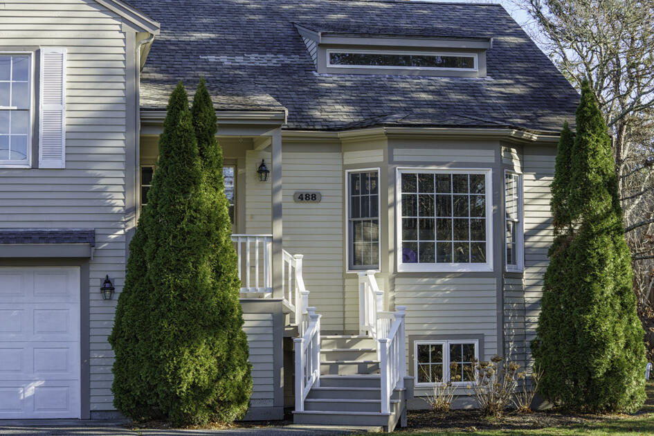 488 Upper County Road Dennis Port, MA 02639 - Photo 2 of 35 a front view of a house with a garden