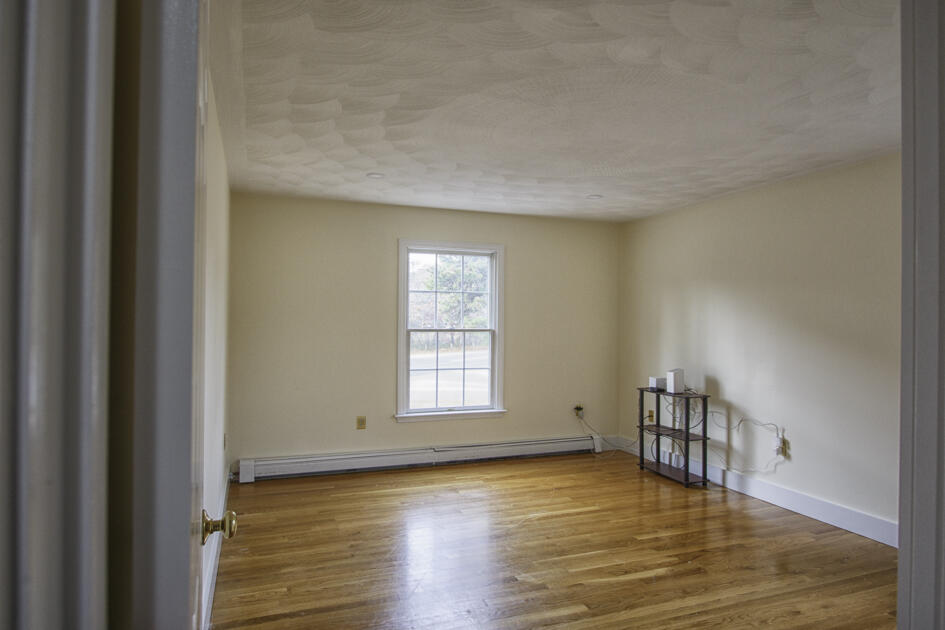 488 Upper County Road Dennis Port, MA 02639 - Photo 23 of 35 a view of empty room with wooden floor and fan
