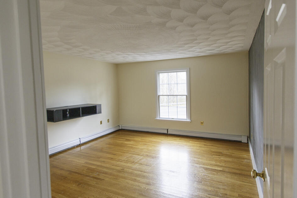 488 Upper County Road Dennis Port, MA 02639 - Photo 24 of 35 an empty room with wooden floor and windows