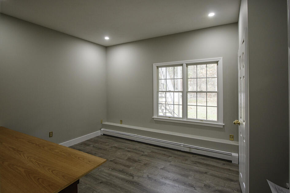 488 Upper County Road Dennis Port, MA 02639 - Photo 28 of 35 an empty room with wooden floor and windows