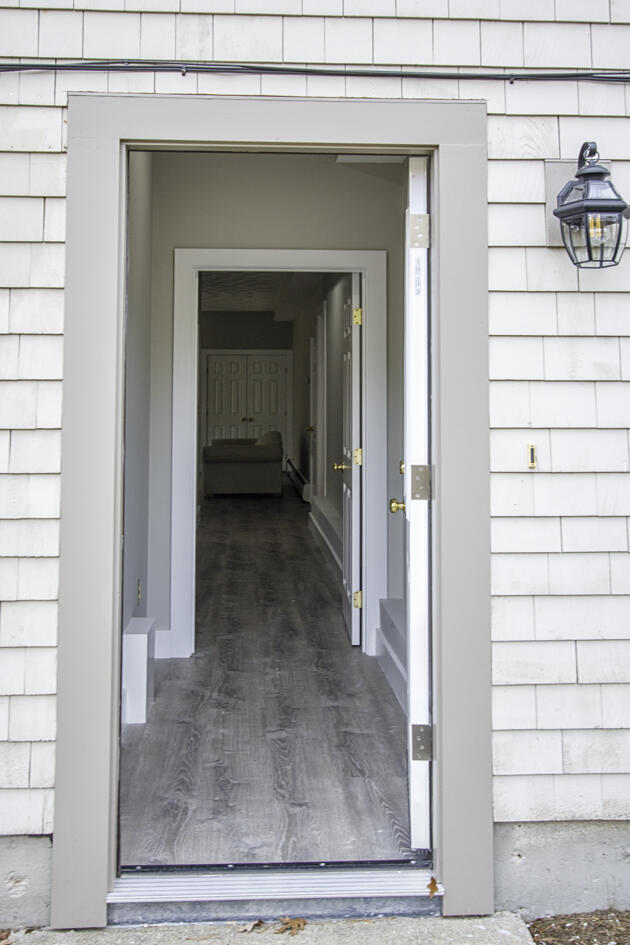 488 Upper County Road Dennis Port, MA 02639 - Photo 34 of 35 a view of a hallway with wooden floor and staircase