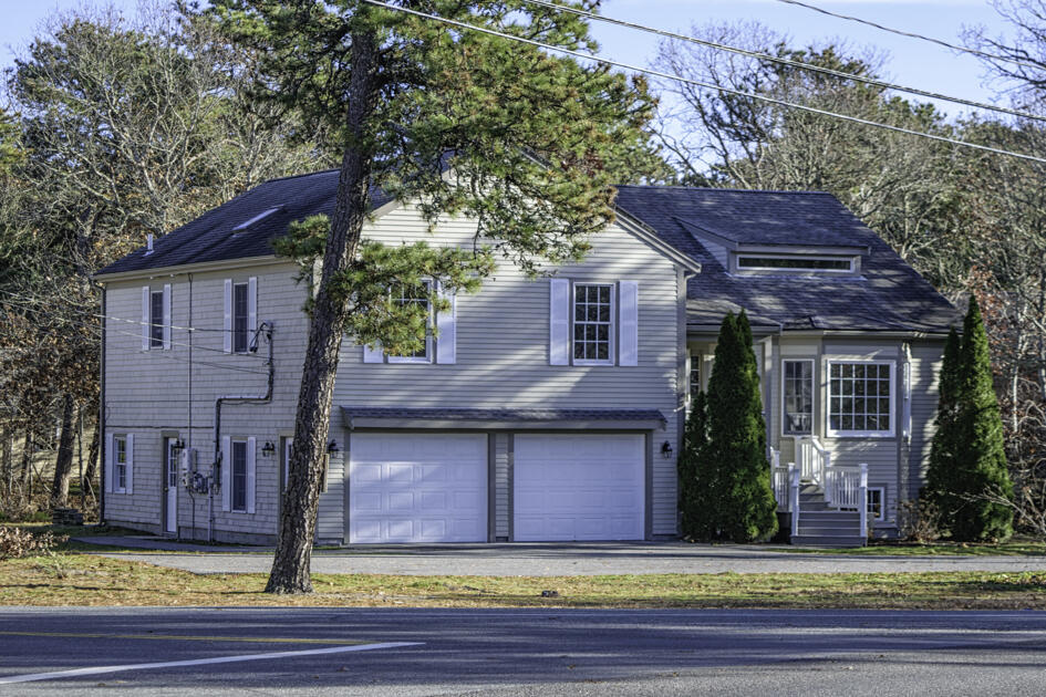 488 Upper County Road Dennis Port, MA 02639 - Photo 4 of 35 a view of a house with a small yard plants and large tree