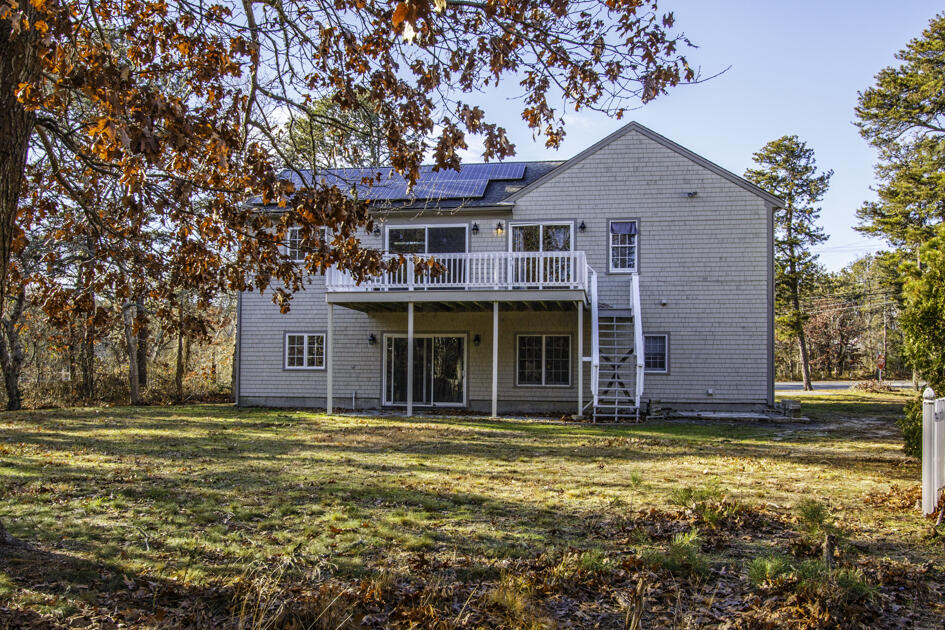488 Upper County Road Dennis Port, MA 02639 - Photo 7 of 35 a front view of a house with a garden