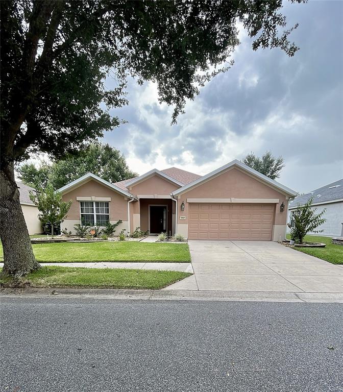 3968 Southwest 57th Terrace Ocala, FL 34474 - Photo 1 of 1 a front view of a house with a garden and trees
