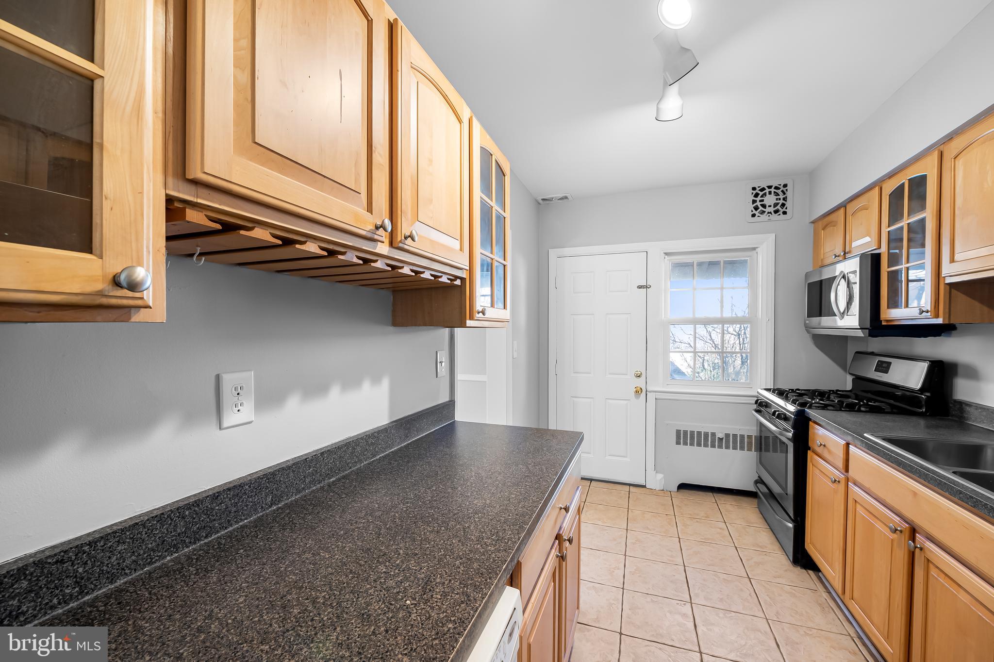 400 Regester Avenue Baltimore, MD 21212 - Photo 14 of 38 a kitchen with stainless steel appliances granite countertop a sink stove and cabinets