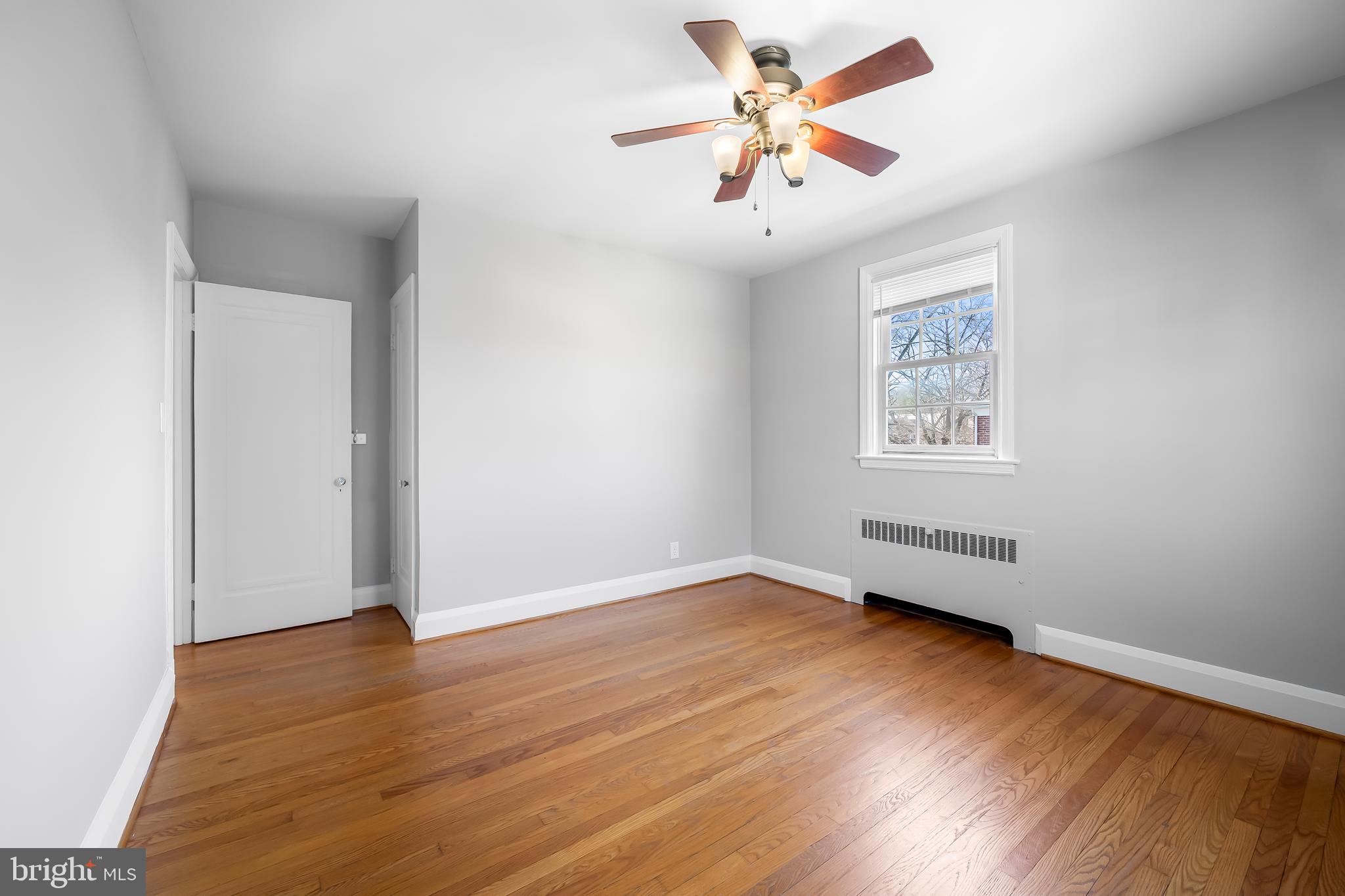 400 Regester Avenue Baltimore, MD 21212 - Photo 19 of 38 an empty room with wooden floor and windows