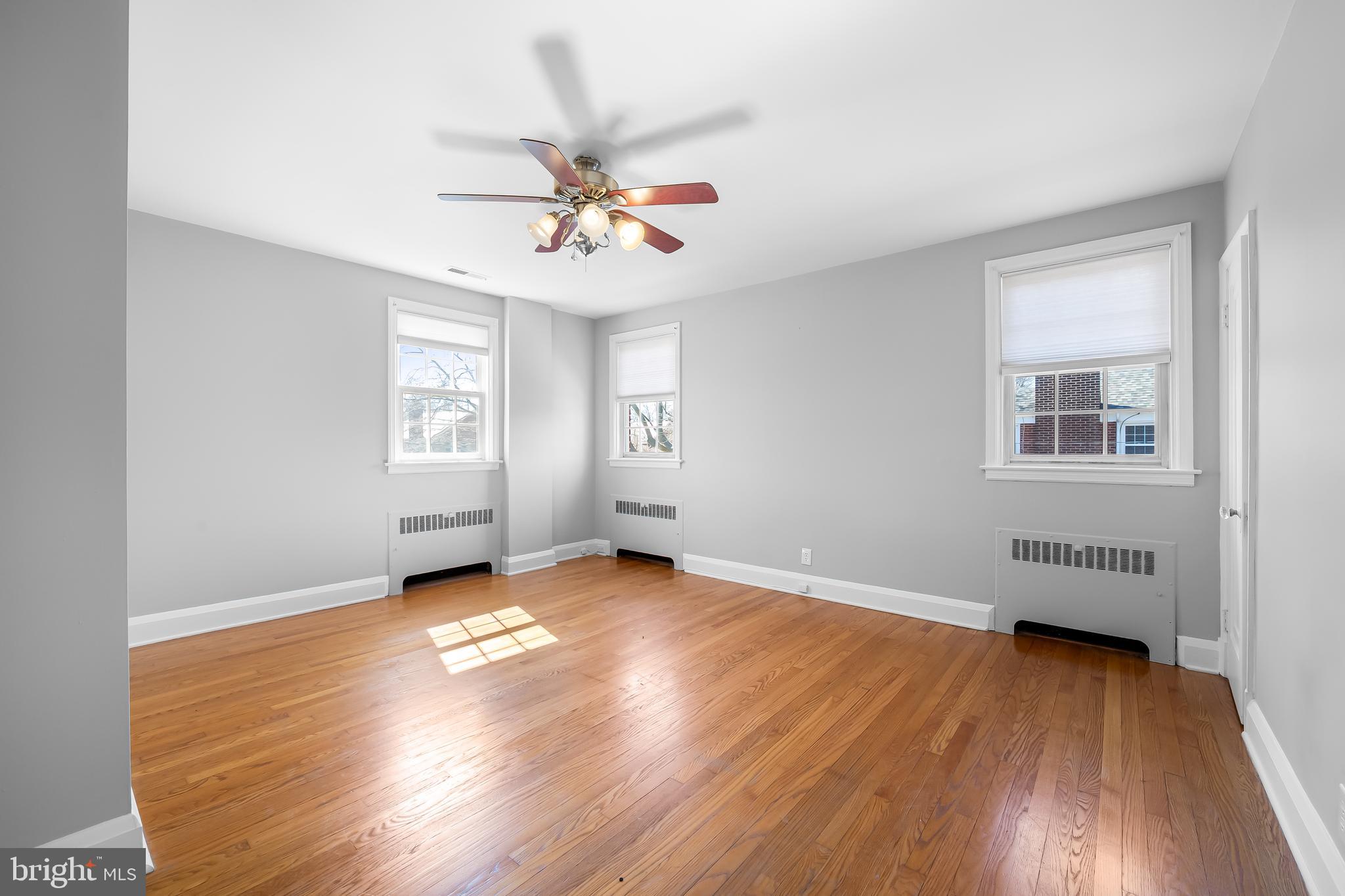 400 Regester Avenue Baltimore, MD 21212 - Photo 20 of 38 a view of an empty room with a window and wooden floor