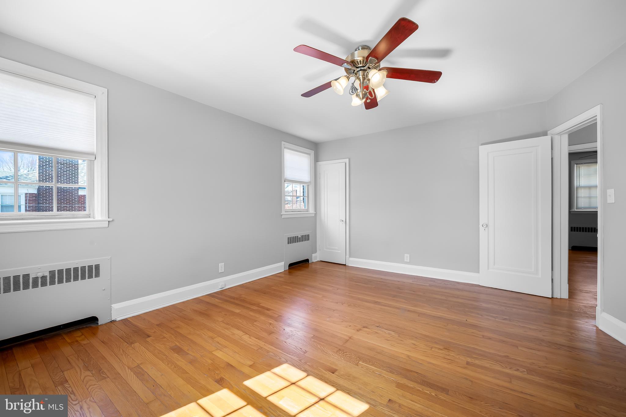 400 Regester Avenue Baltimore, MD 21212 - Photo 22 of 38 a view of an empty room with window and wooden floor