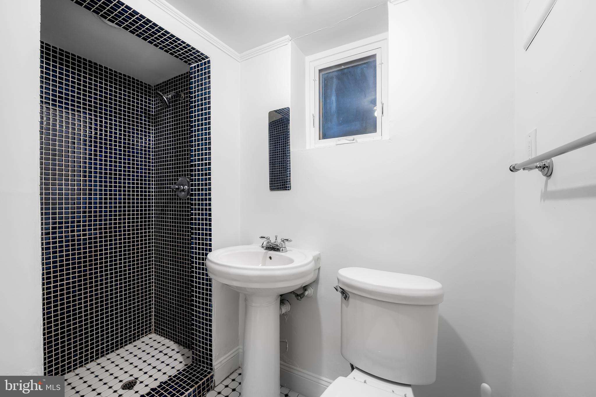 400 Regester Avenue Baltimore, MD 21212 - Photo 30 of 38 a bathroom with a sink toilet and shower
