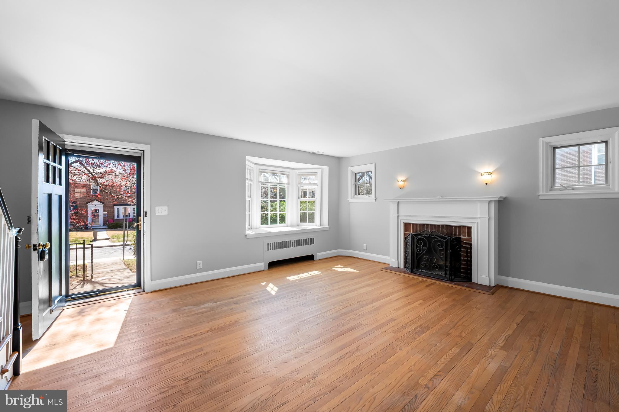 400 Regester Avenue Baltimore, MD 21212 - Photo 3 of 38 an empty room with windows fireplace and windows