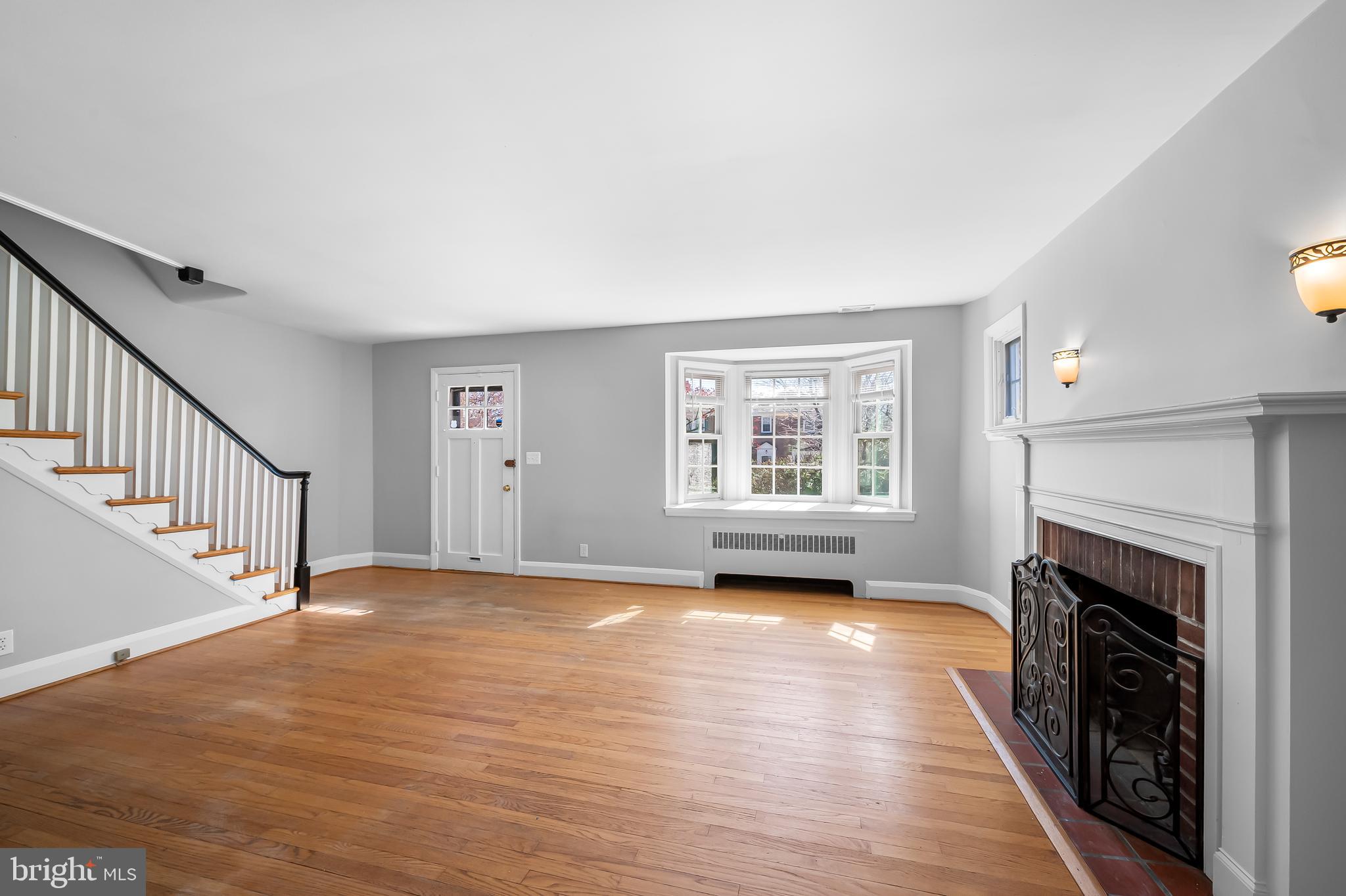 400 Regester Avenue Baltimore, MD 21212 - Photo 5 of 38 a view of empty room with fireplace and wooden floor