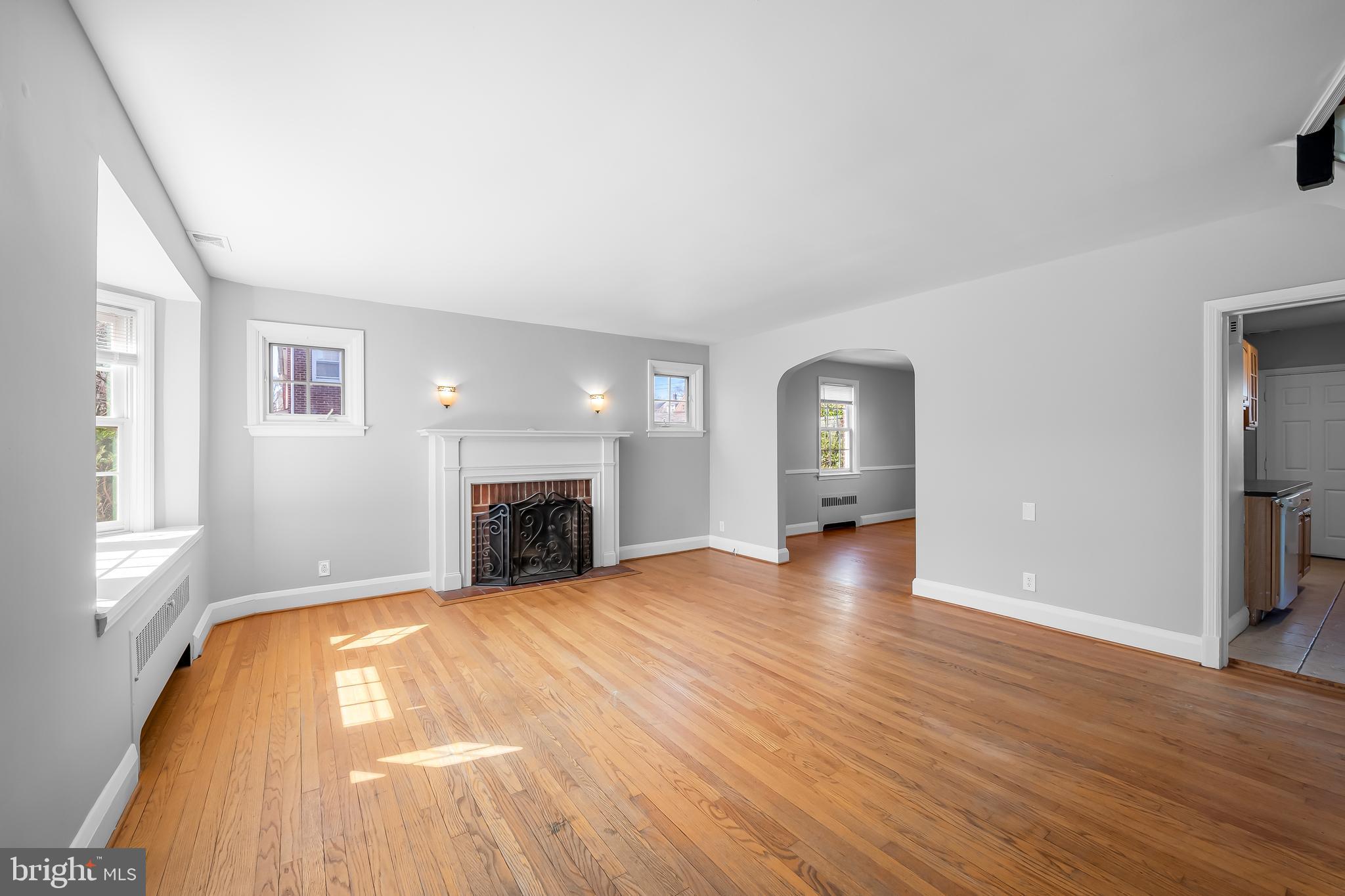 400 Regester Avenue Baltimore, MD 21212 - Photo 7 of 38 a view of empty room with wooden floor and fireplace