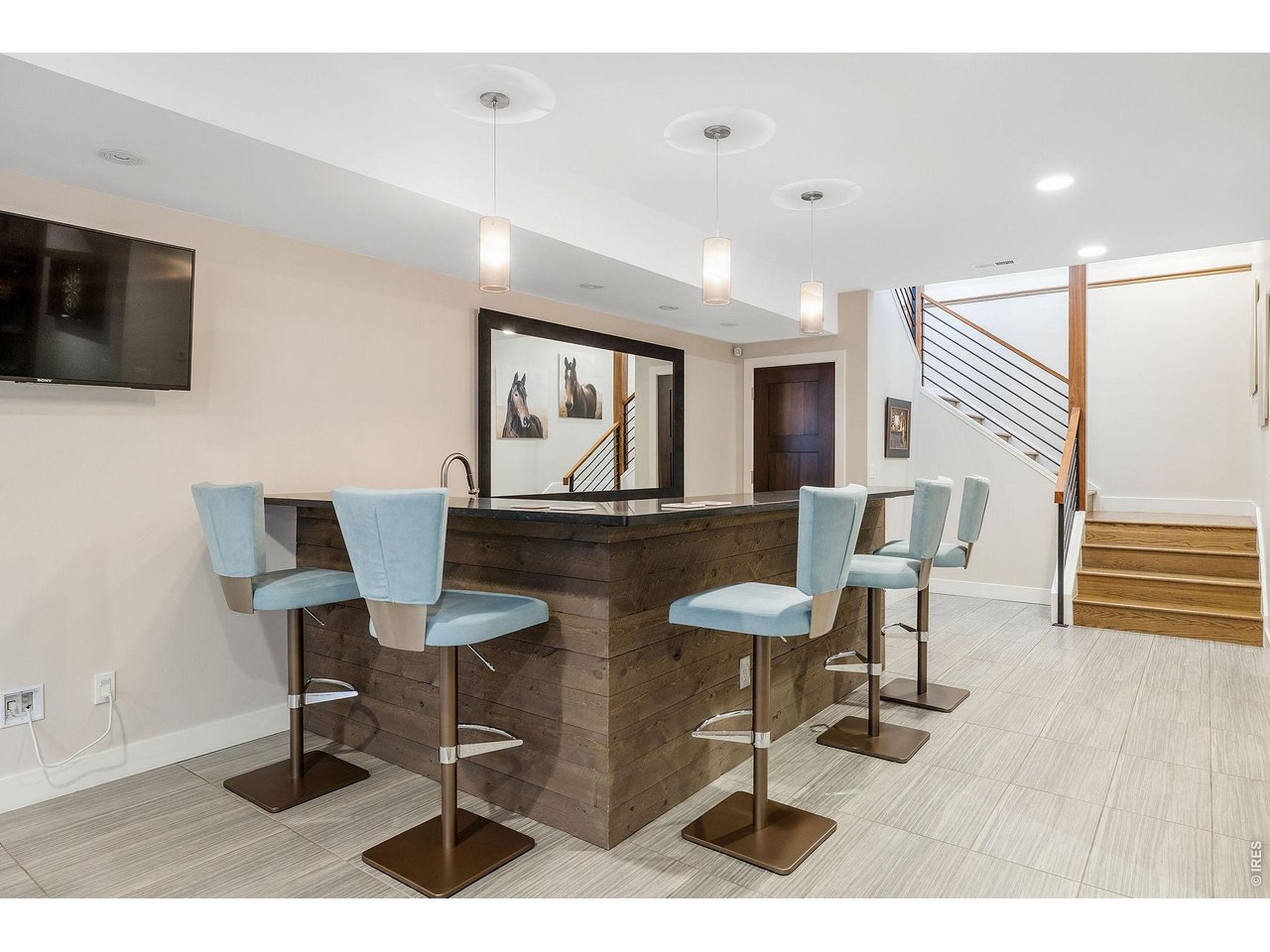 1525 Jennine Place Boulder, CO 80304 - Photo 37 of 50 Fun and games await on the carpeted lower level, where a huge family room and media/game area are anchored by a walk-up bar and illuminated by large egress windows.