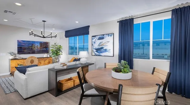 a bedroom with a bed window and potted plant on the dresser