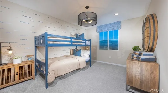 a spacious bedroom with a bed and a chandelier