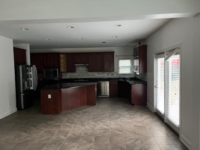 44 Kent Valley Circle Tucker, GA 30084 - Photo 2 of 6 a kitchen with stainless steel appliances granite countertop a refrigerator and a sink