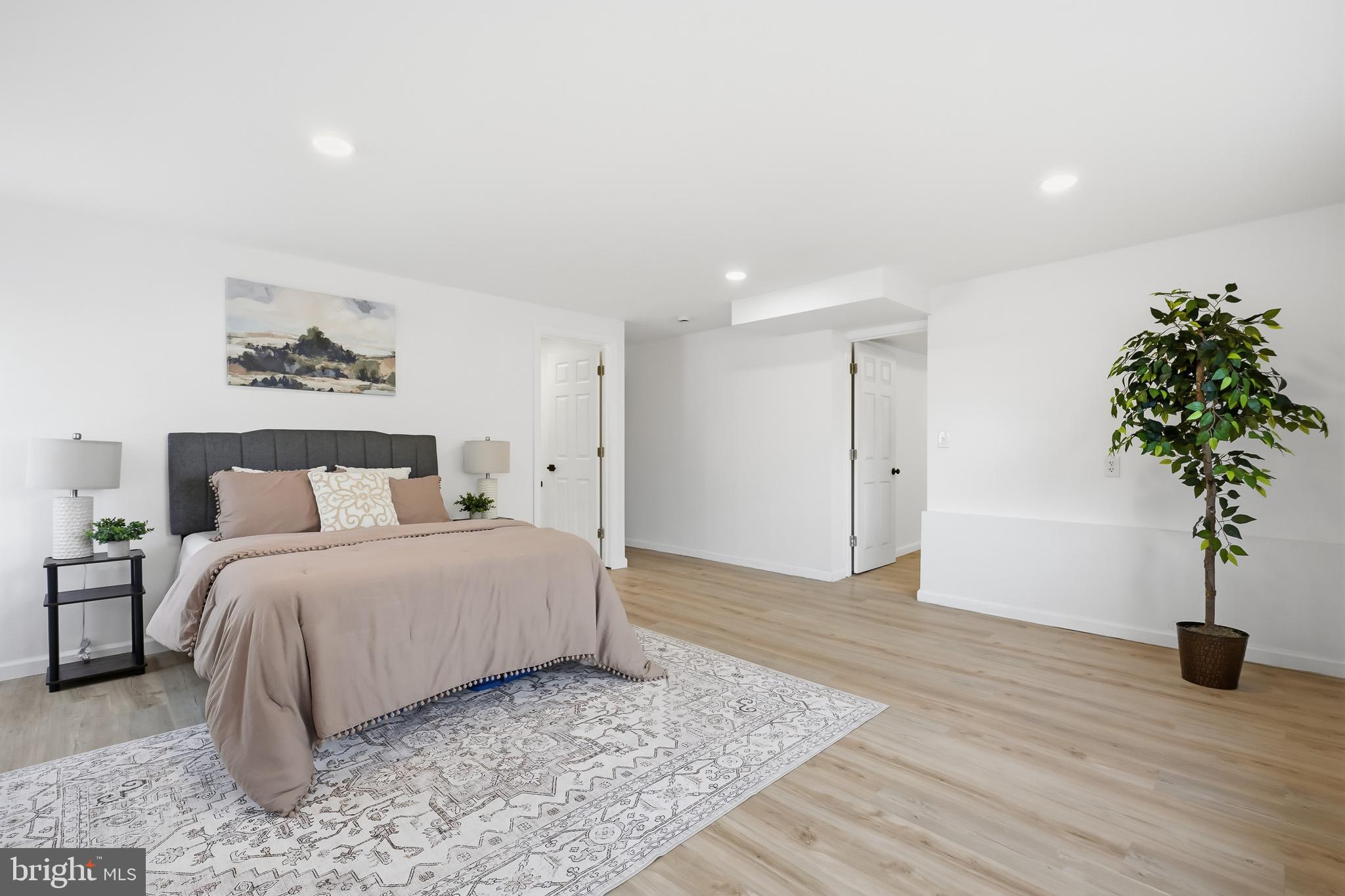 4740 Lake Road Newfield, NJ 08344 - Photo 11 of 29 a spacious bedroom with a bed and a plant