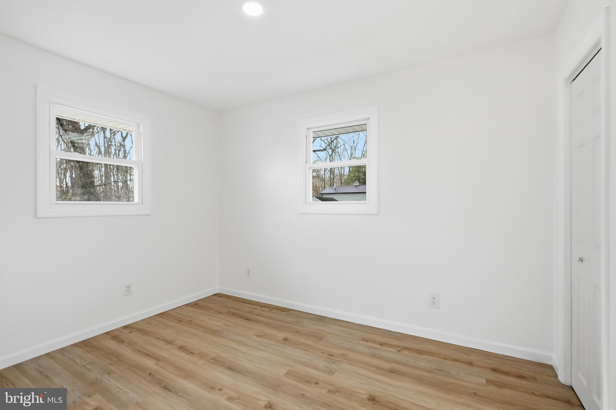 4740 Lake Road Newfield, NJ 08344 - Photo 16 of 29 a view of empty room with wooden floor and fan