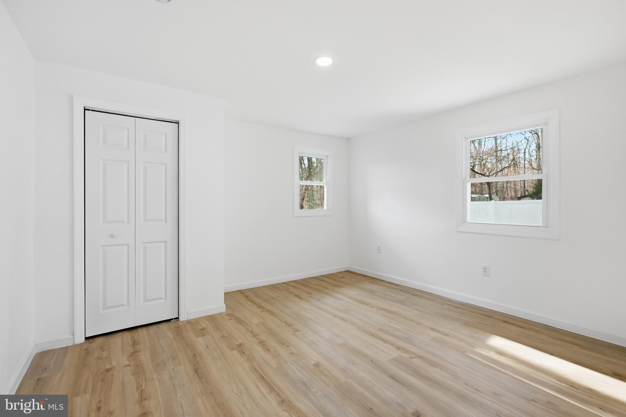 4740 Lake Road Newfield, NJ 08344 - Photo 19 of 29 a view of an empty room with wooden floor and a window