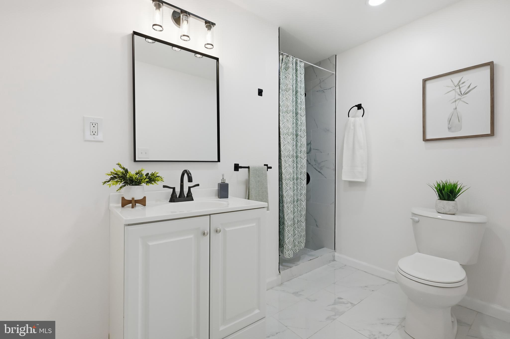 4740 Lake Road Newfield, NJ 08344 - Photo 6 of 29 a bathroom with a sink a toilet and shower