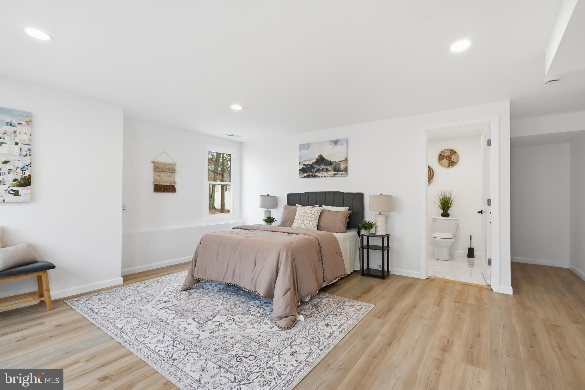 4740 Lake Road Newfield, NJ 08344 - Photo 10 of 29 a spacious bedroom with a bed and wooden floor