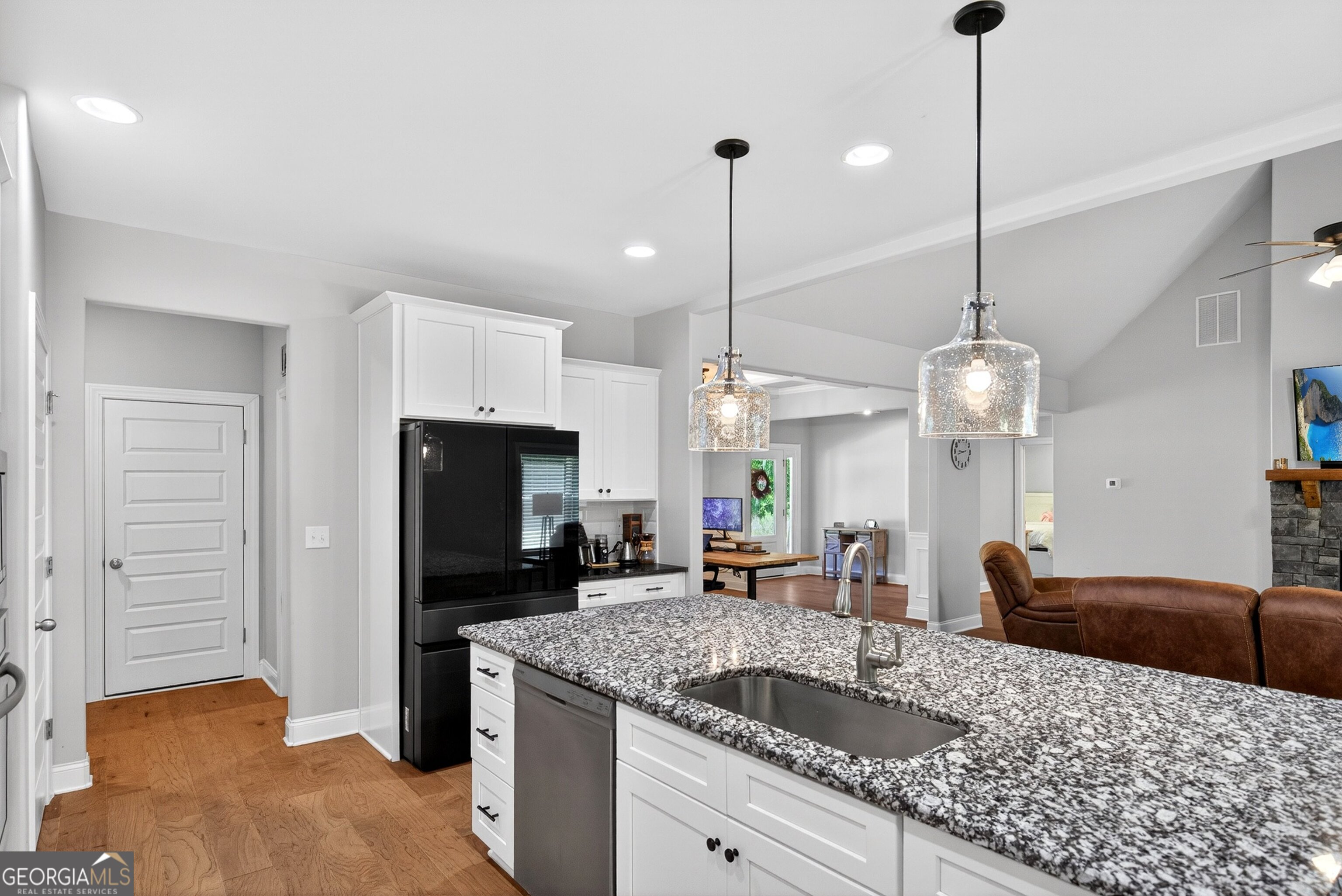 1764 Luther Bailey Road Senoia, GA 30276 - Photo 18 of 63 a kitchen with kitchen island granite countertop a sink a counter space appliances and cabinets