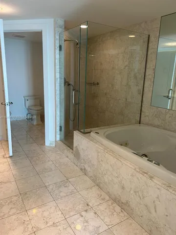 a bathroom with a shower and a sink