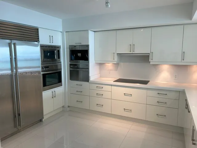 a view of an empty room and fire place