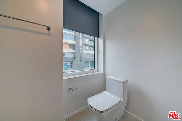 a white toilet sitting next to a bathroom sink