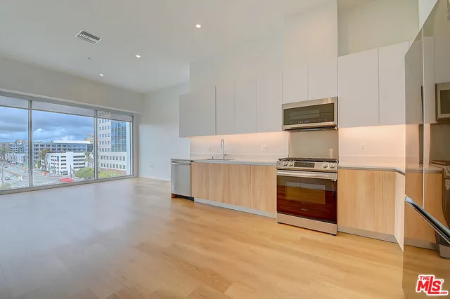 a kitchen with stainless steel appliances a refrigerator and a stove