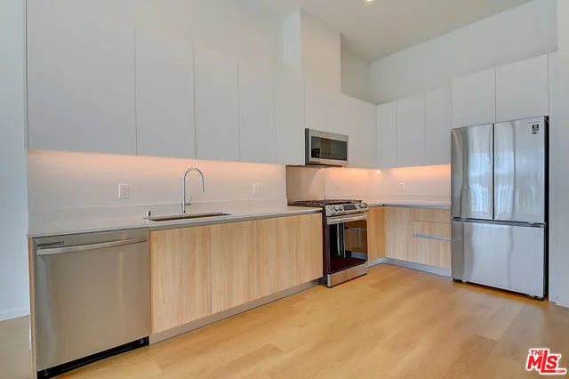 a kitchen with a refrigerator sink and microwave