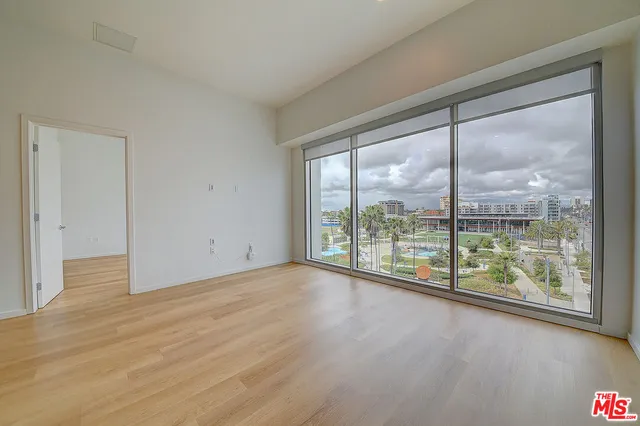 a view of a room with wooden floor and doors