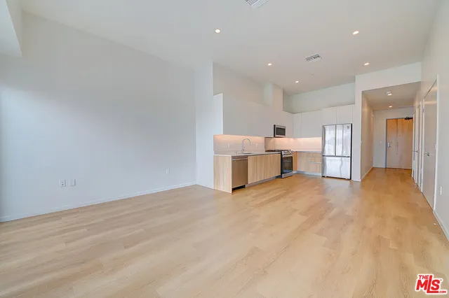 a view of kitchen with furniture and wooden floor