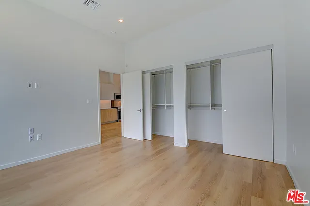 a view of a room with wooden floor and windows