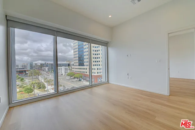 a kitchen with a stove top oven and refrigerator
