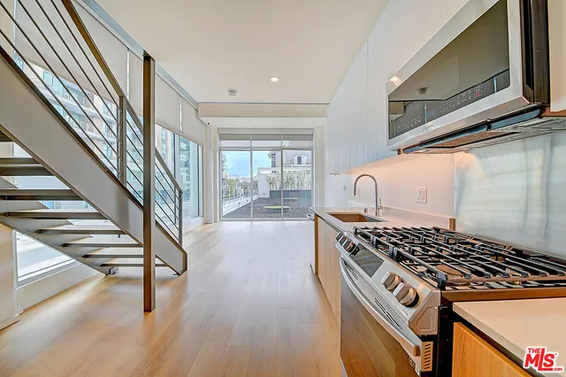 a kitchen with wooden cabinets and a stove top oven