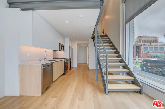 a view of kitchen and hall with wooden floor