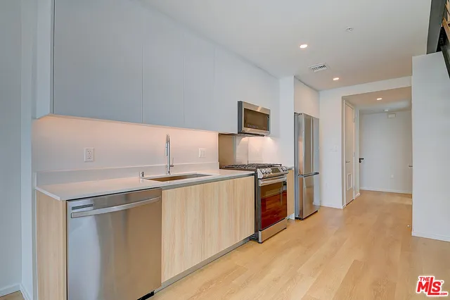 a kitchen with a sink appliances and cabinets