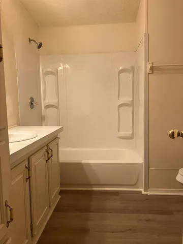a bathroom with a double vanity sink a mirror and a bathtub