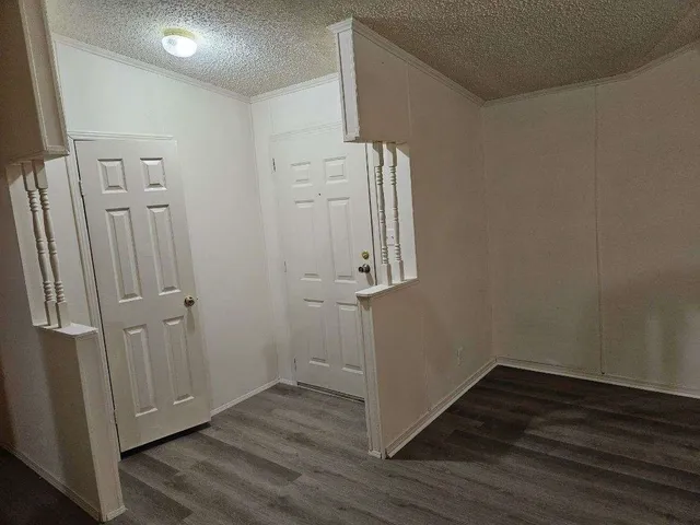 an empty room with wooden floor and closet