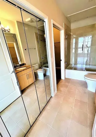 an empty room with ceiling fan and window