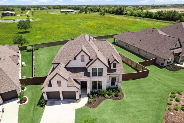 an aerial view of a house with big yard