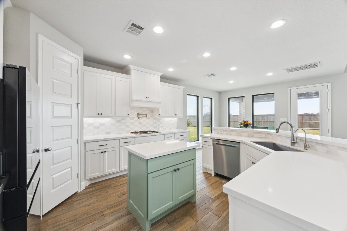9951 Chapman Trail Manvel, TX 77578 - Photo 13 of 50 a kitchen with white cabinets appliances and sink