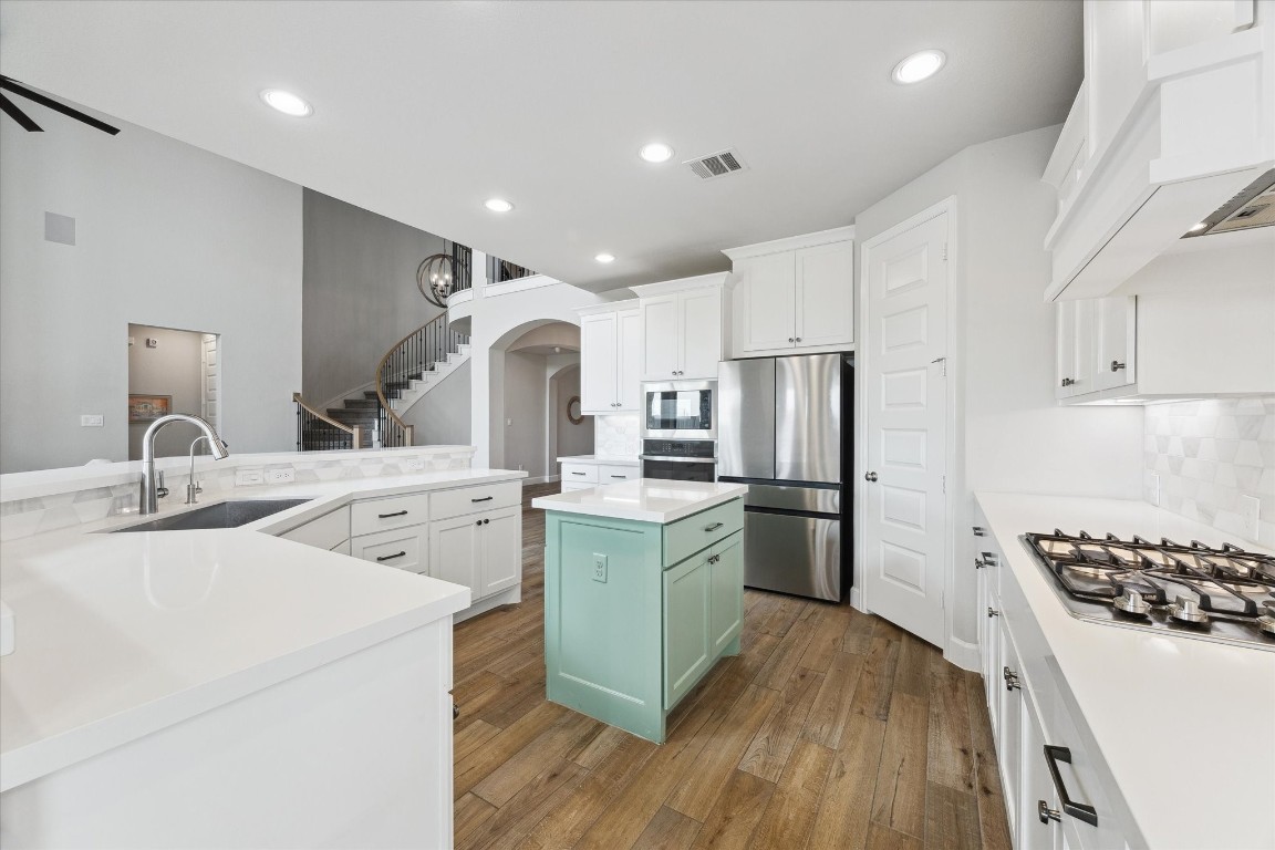 9951 Chapman Trail Manvel, TX 77578 - Photo 14 of 50 a kitchen with a sink stainless steel appliances and cabinets
